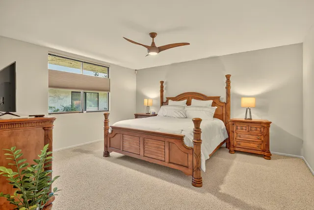 a bedroom with a large bed and a window