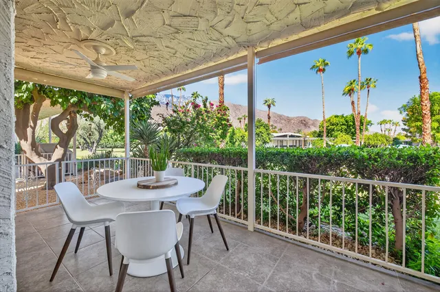 a view of a patio with a table chairs and a table