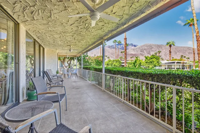 a porch with a table and chairs