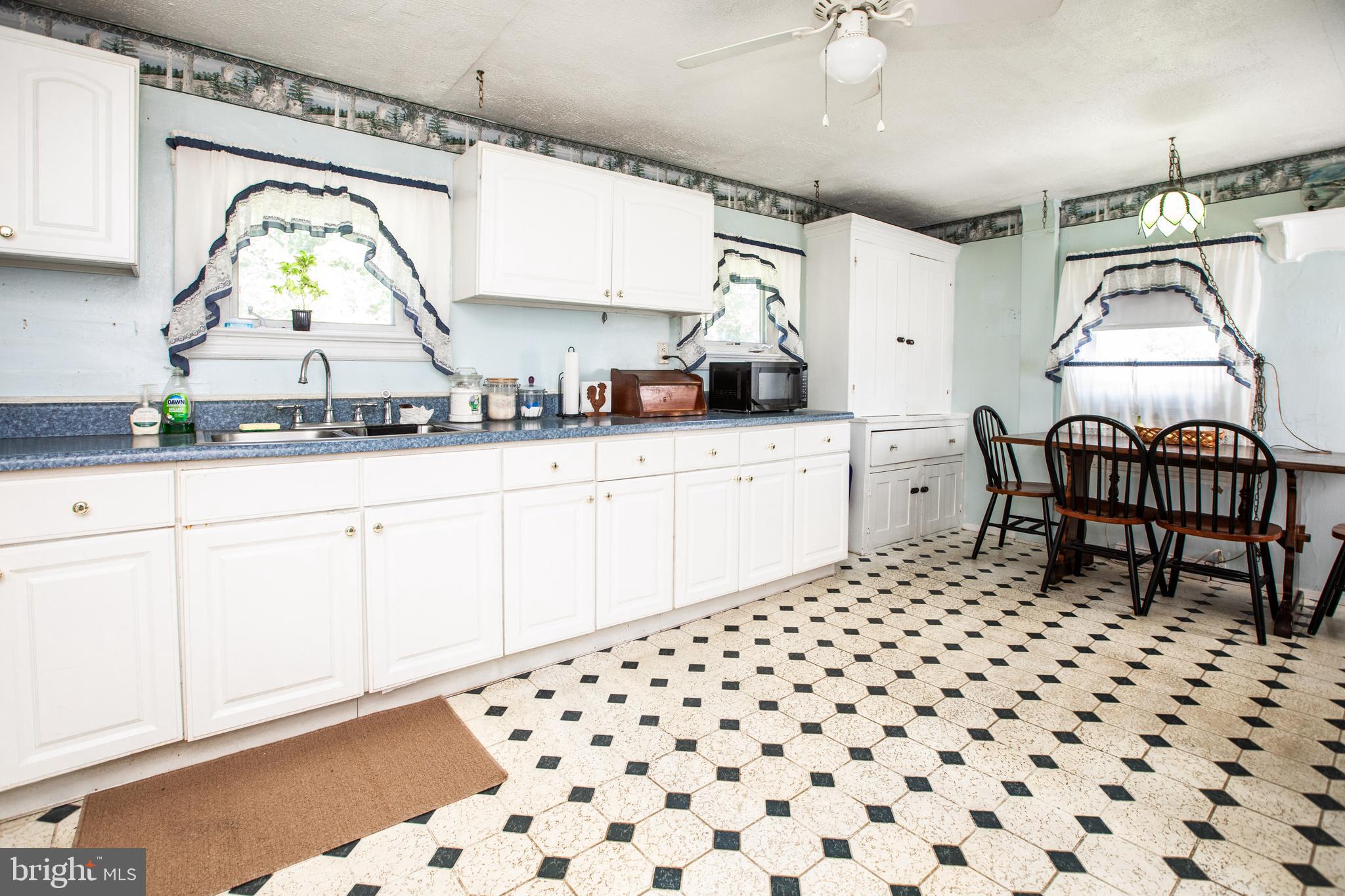 752 Groveville Road Hamilton, NJ 08620 - Photo 14 of 33 a kitchen with granite countertop a sink a window and stainless steel appliances