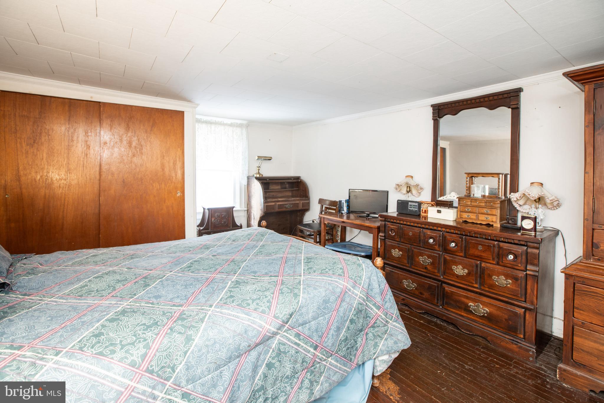 752 Groveville Road Hamilton, NJ 08620 - Photo 17 of 33 a bedroom with a bed and wooden floor