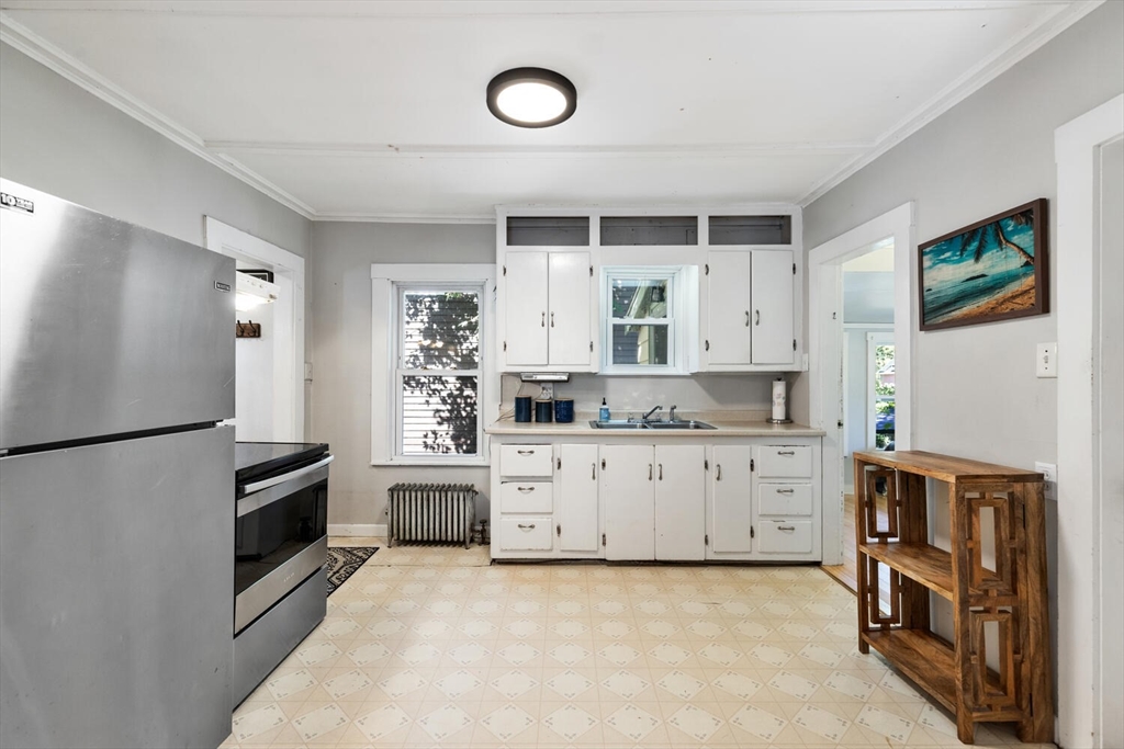 12 Harold Avenue Gloucester, MA 01930 - Photo 9 of 23 a kitchen with stainless steel appliances a refrigerator sink and cabinets