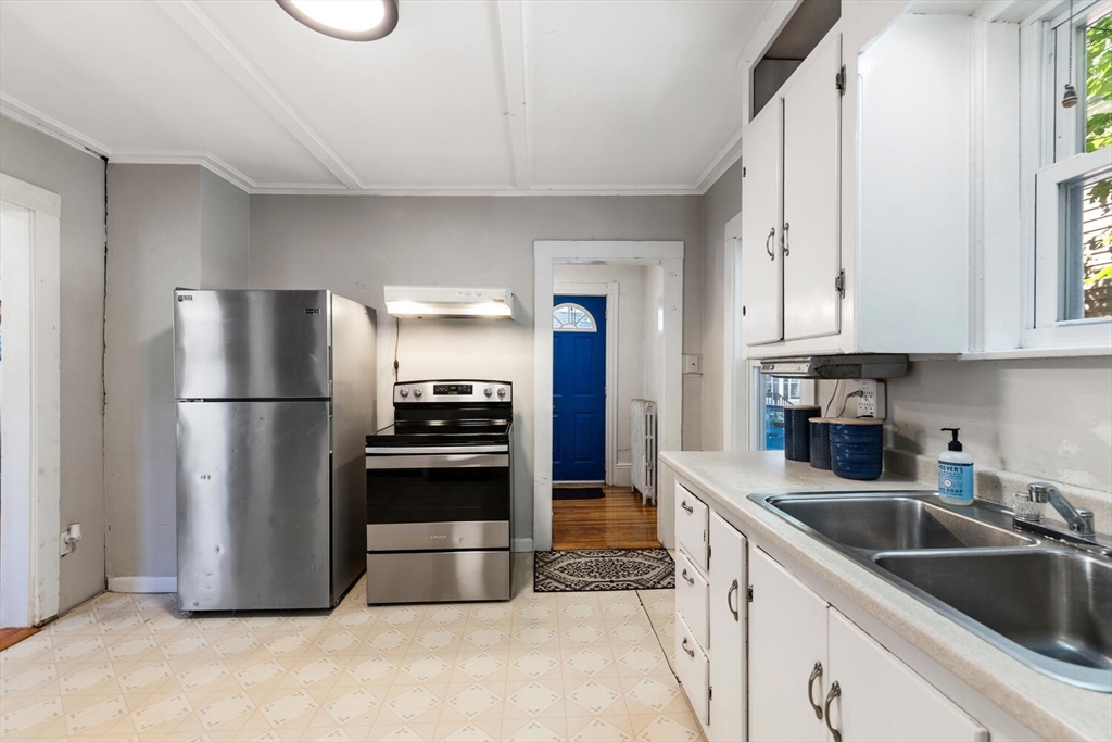 12 Harold Avenue Gloucester, MA 01930 - Photo 10 of 23 a kitchen with stainless steel appliances granite countertop a refrigerator a stove a sink and a refrigerator