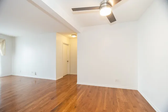 a view of a room with wooden floor and white walls