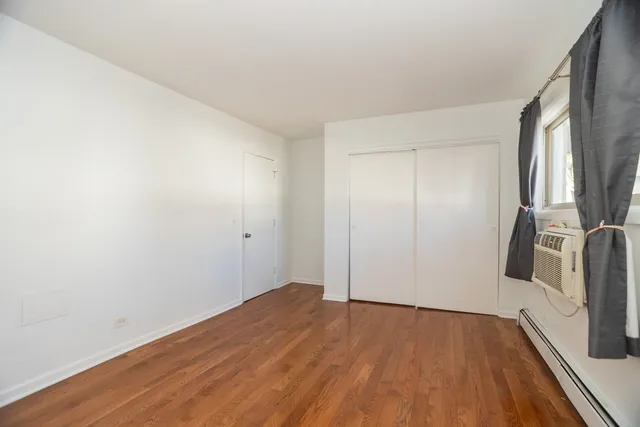 a view of a room with wooden floor and a sink