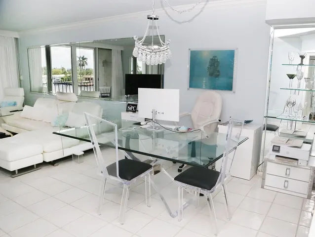 a living room with furniture and white walls with rug