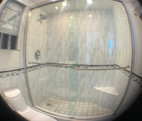 a bathroom with a sink mirror and toilet