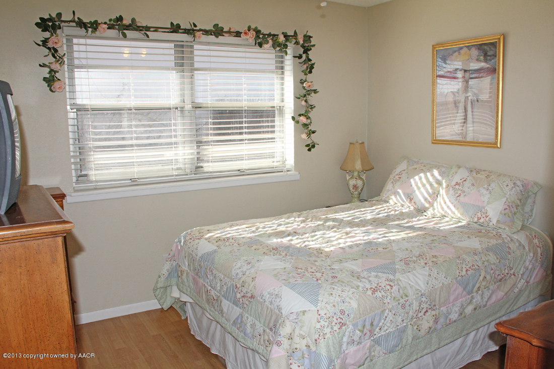 5324 Allen Street Amarillo, TX 79110 - Photo 17 of 24 a bedroom with a bed and a window