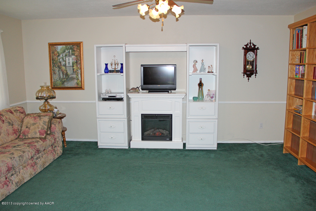 5324 Allen Street Amarillo, TX 79110 - Photo 3 of 24 a living room with furniture a flat screen tv and a fireplace