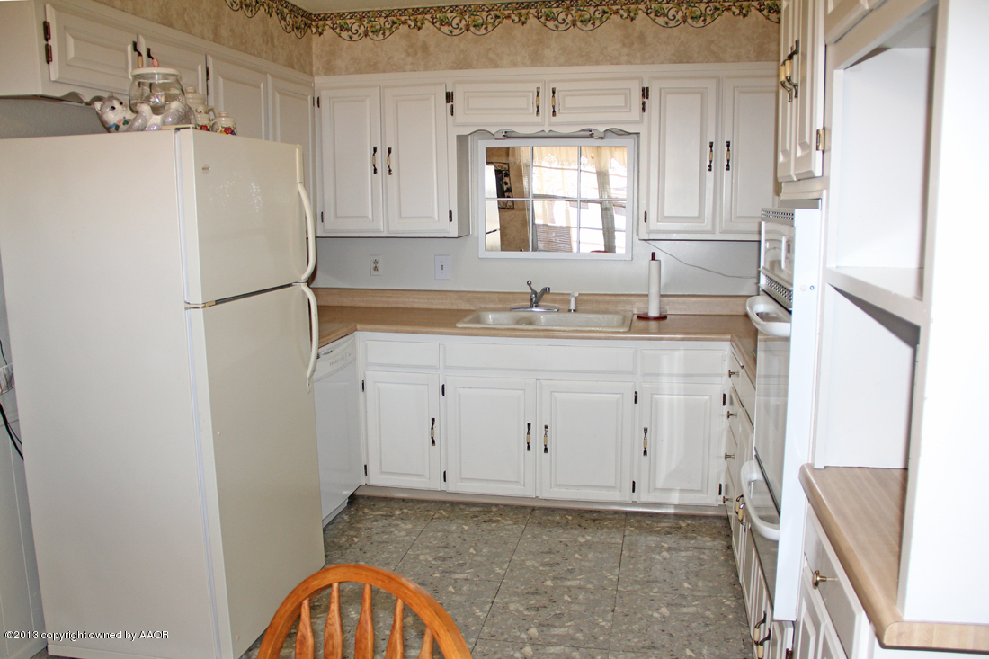 5324 Allen Street Amarillo, TX 79110 - Photo 7 of 24 a white refrigerator freezer sitting inside of a kitchen