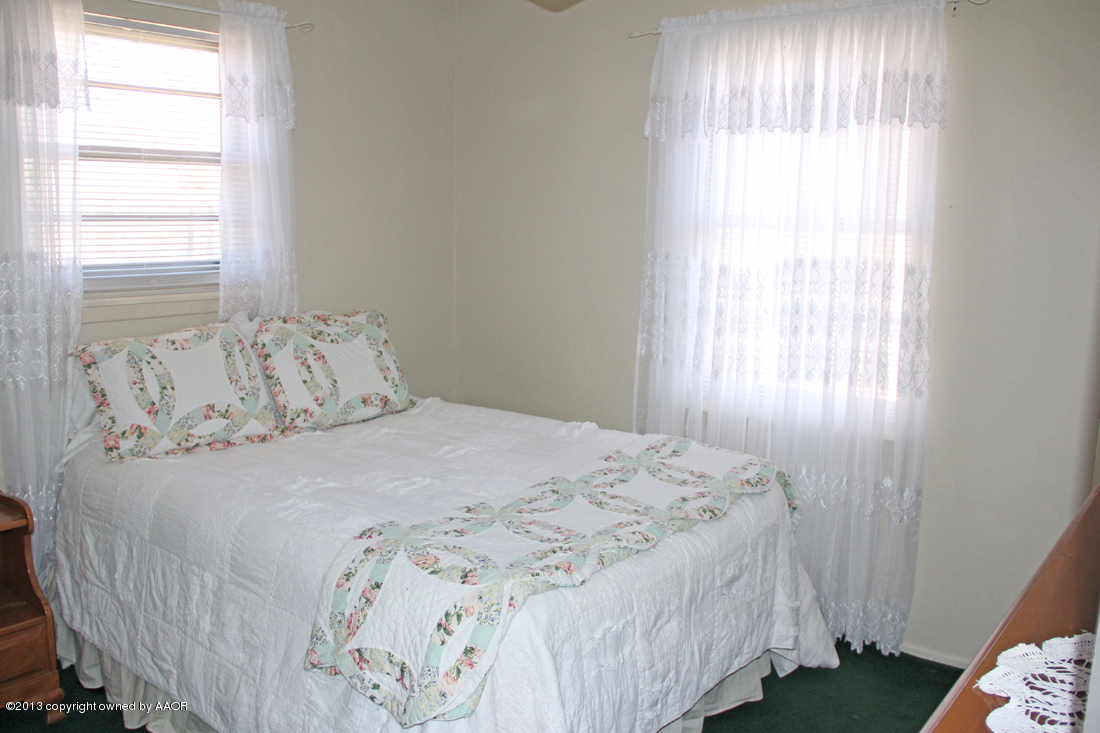 5324 Allen Street Amarillo, TX 79110 - Photo 9 of 24 a bedroom with a bed and a window