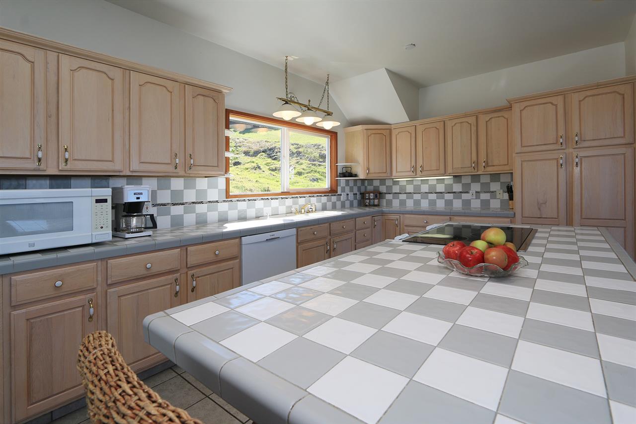 1415 Middle Road Kula, HI 96790 - Photo 18 of 30 a kitchen with stainless steel appliances a sink a stove a microwave and cabinets