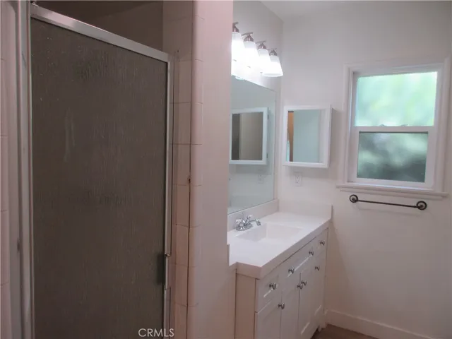 a bathroom with a sink vanity and mirror