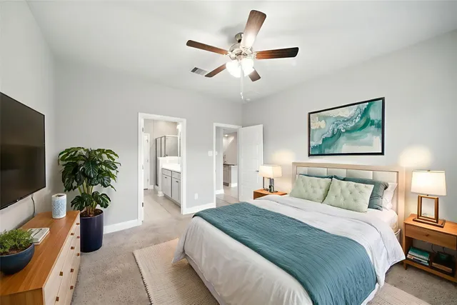 a bedroom with a large bed and a chandelier