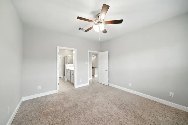 an empty room with closet and windows