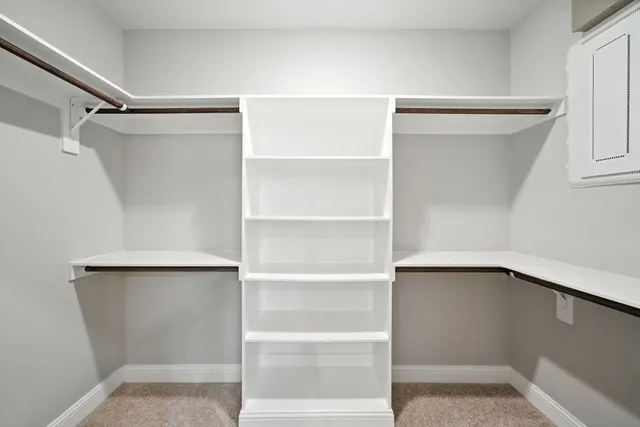 a view of walk in closet with empty racks