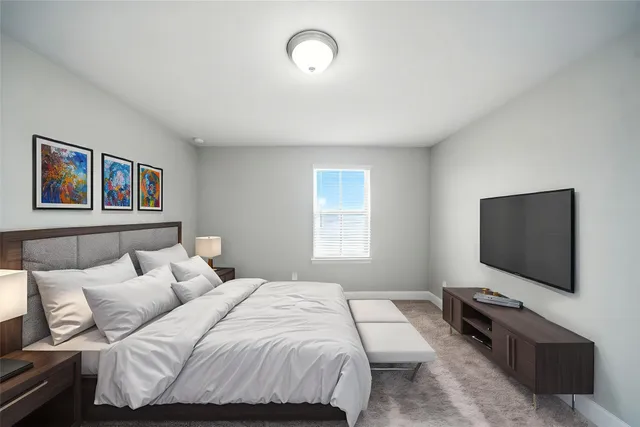 a bedroom with a bed and a flat screen tv