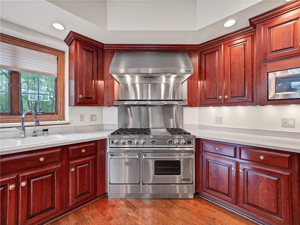 9290 Peebles Road Allison Park, PA 15101 - Photo 8 of 25 a kitchen with wooden cabinets and a stove top oven