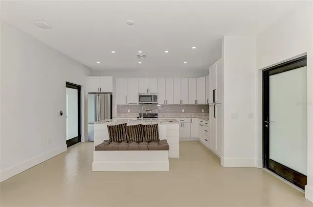 a kitchen with stainless steel appliances a refrigerator and a stove top oven