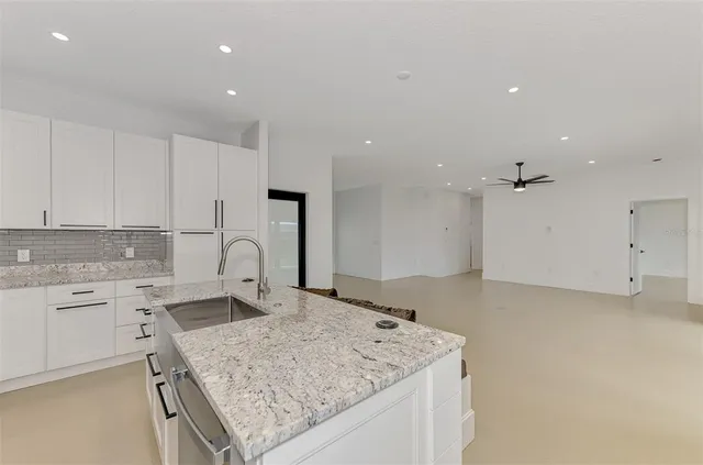 a kitchen with a sink stove and refrigerator