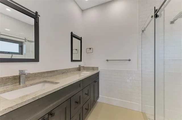 a bathroom with a granite countertop sink mirror and double