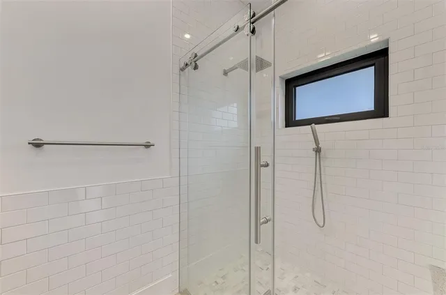 a bathroom with a shower and a shower