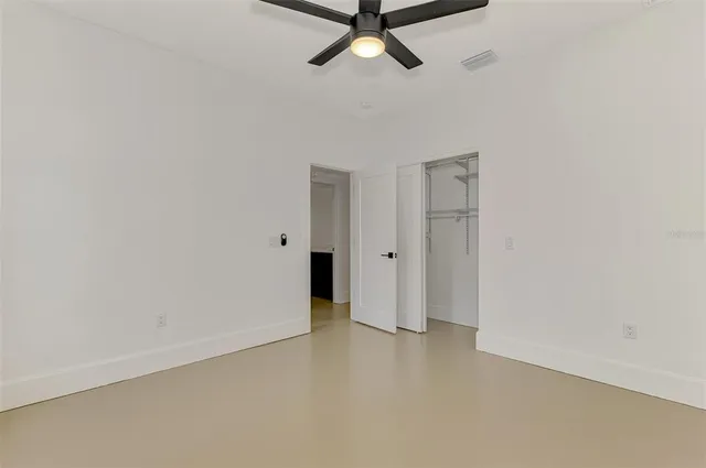a view of a room with a ceiling fan