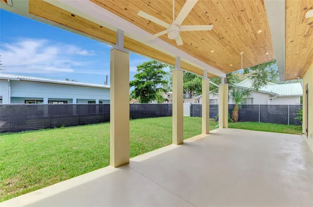 a view of an house with backyard and balcony
