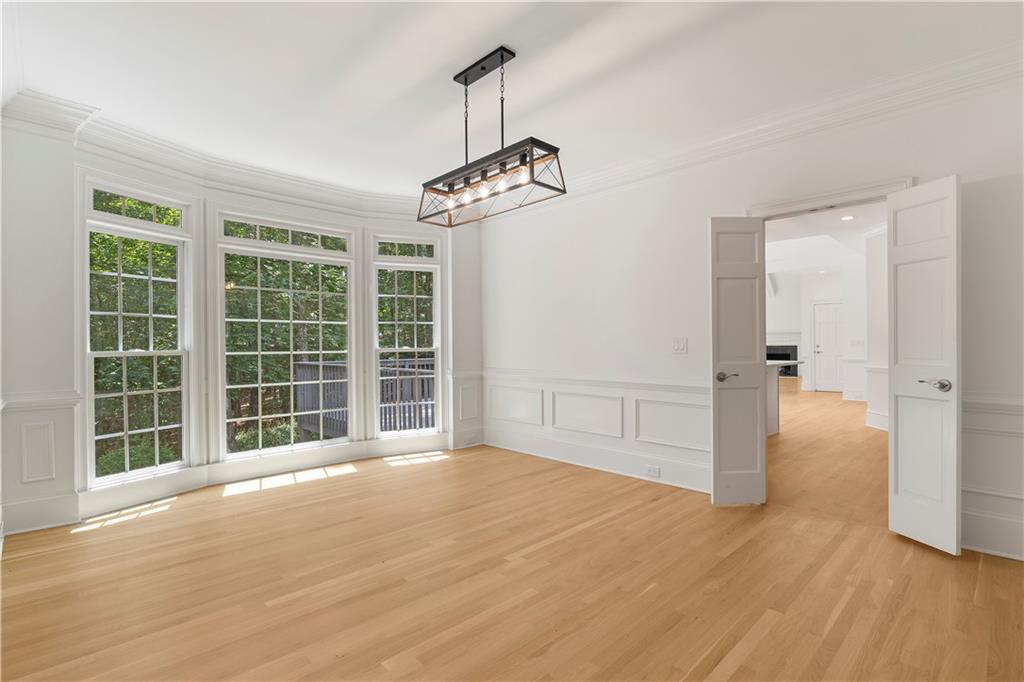 8965 Laurel Way Alpharetta, GA 30022 - Photo 18 of 79 a view of an empty room with a window and wooden floor