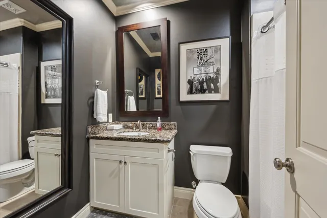 a bathroom with a toilet a sink and mirror