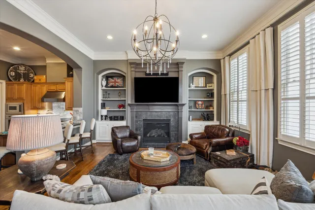 a living room with fireplace furniture and a large window