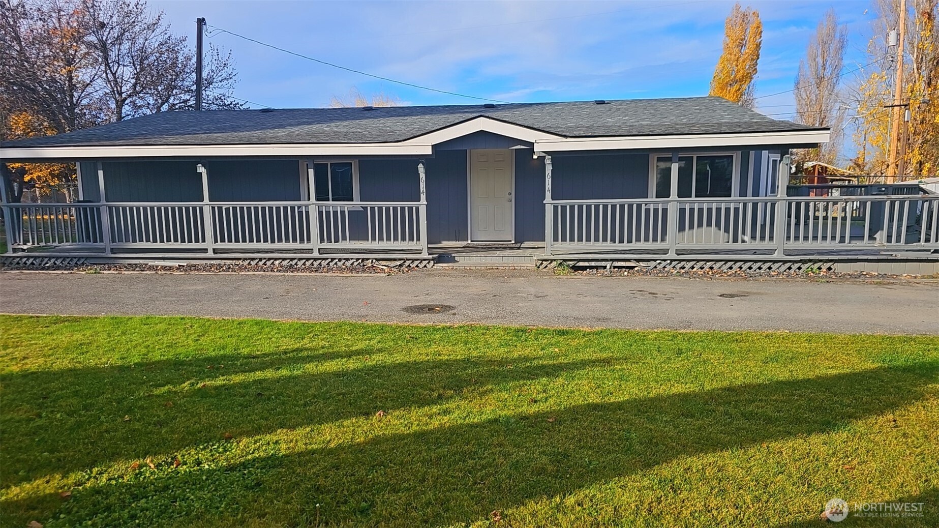a front view of a house with a garden and yard
