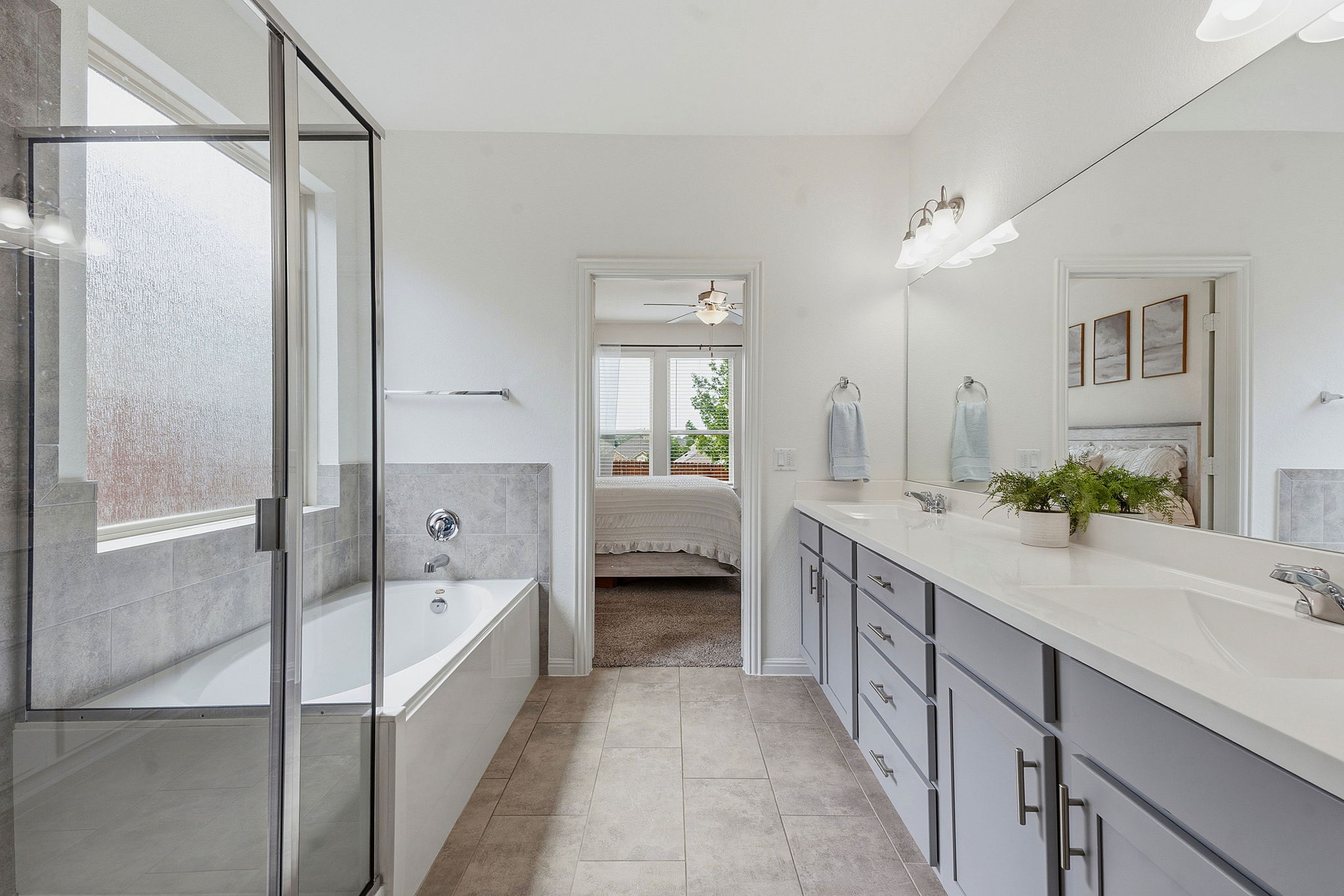 609 Allende Bend, Unit 130 Austin, TX 78748 - Photo 18 of 33 a spacious en suite bathroom with a granite countertop tub double vanity and a shower