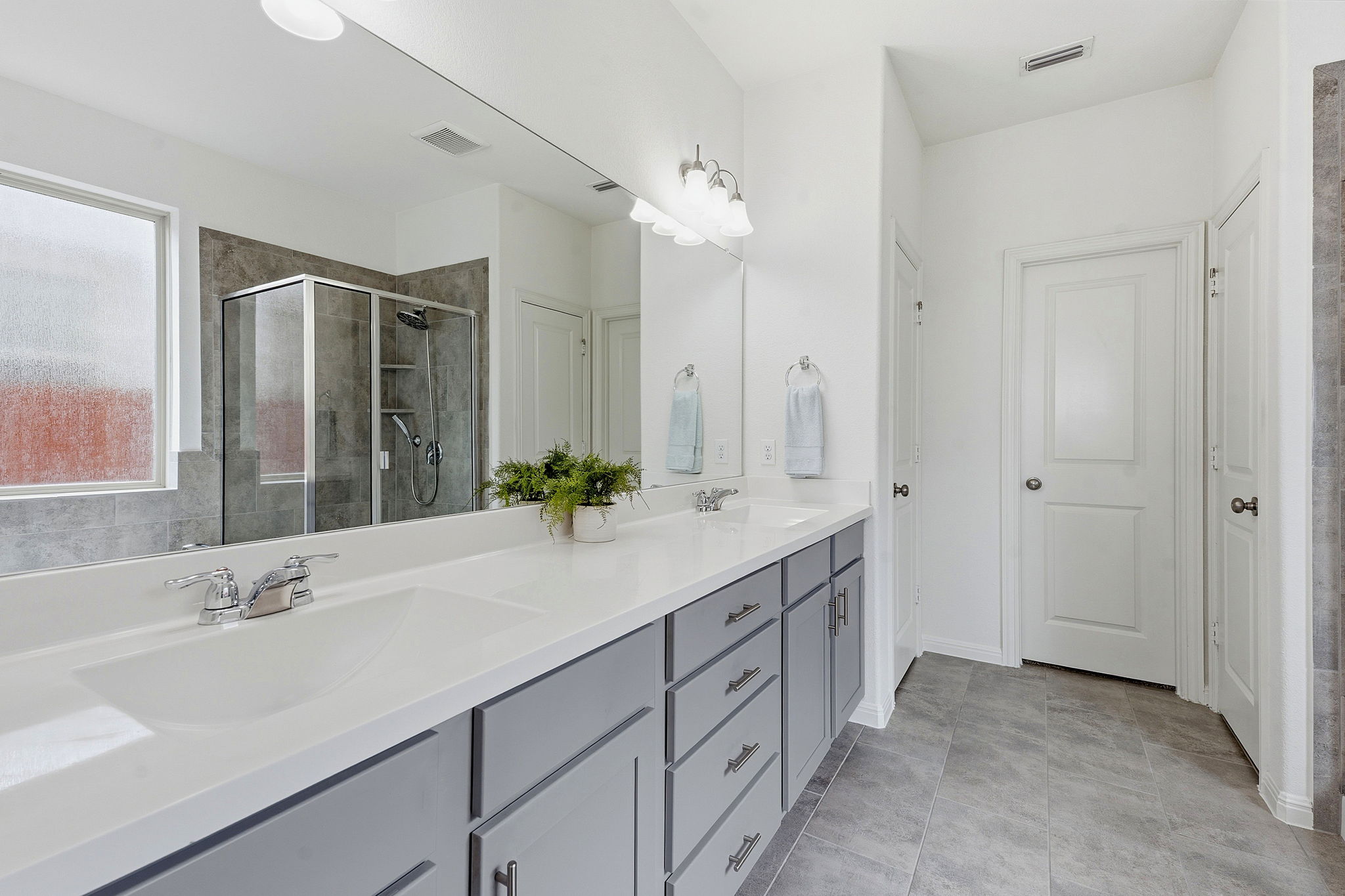 609 Allende Bend, Unit 130 Austin, TX 78748 - Photo 19 of 33 a bathroom with double vanity sinks and a large mirror