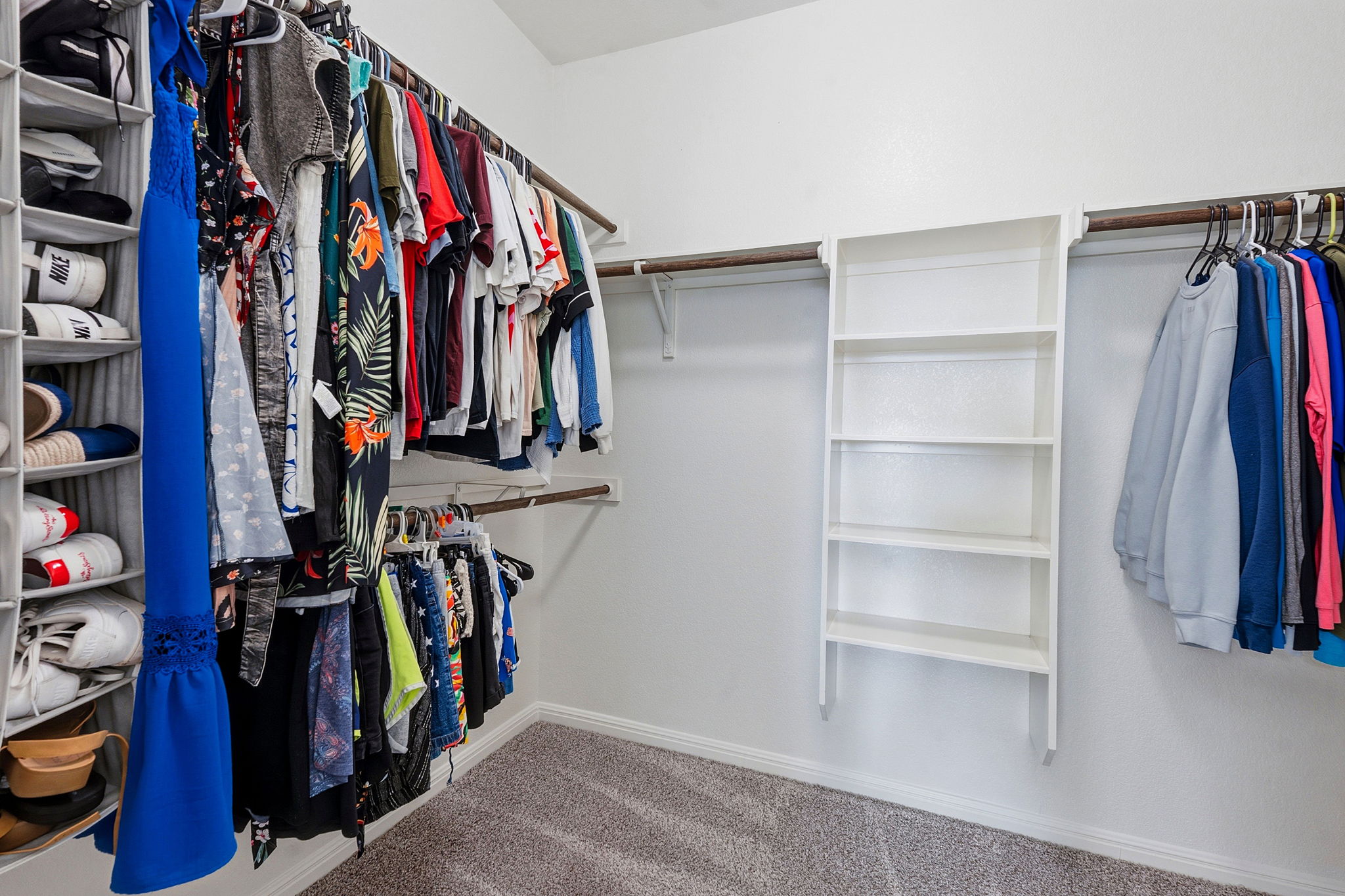 609 Allende Bend, Unit 130 Austin, TX 78748 - Photo 21 of 33 a view of walk in closet with clothes and shoes