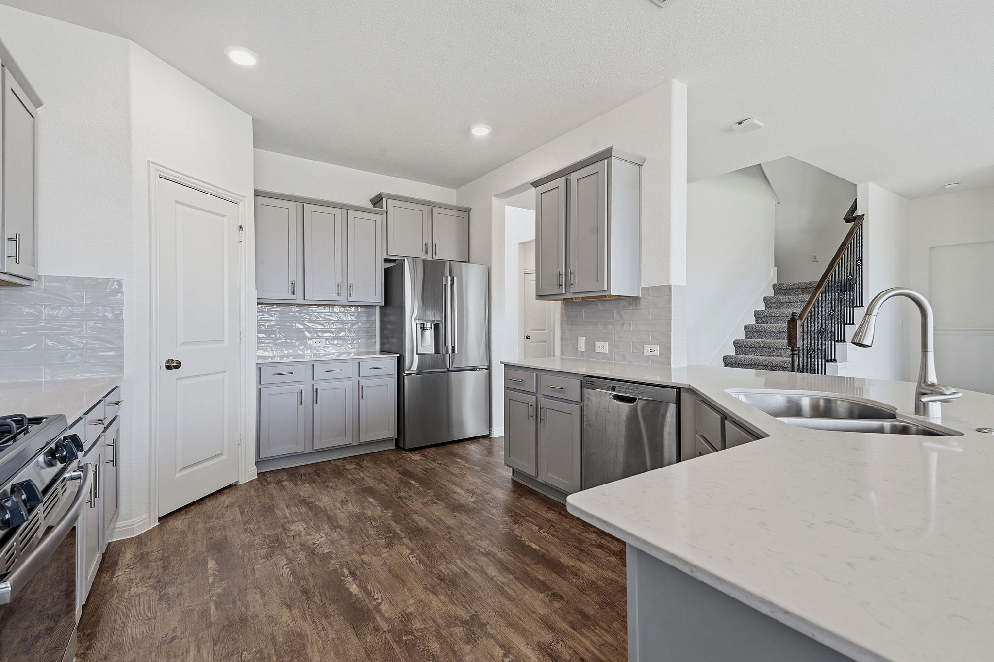 609 Allende Bend, Unit 130 Austin, TX 78748 - Photo 6 of 33 a kitchen with refrigerator cabinets and wooden floor
