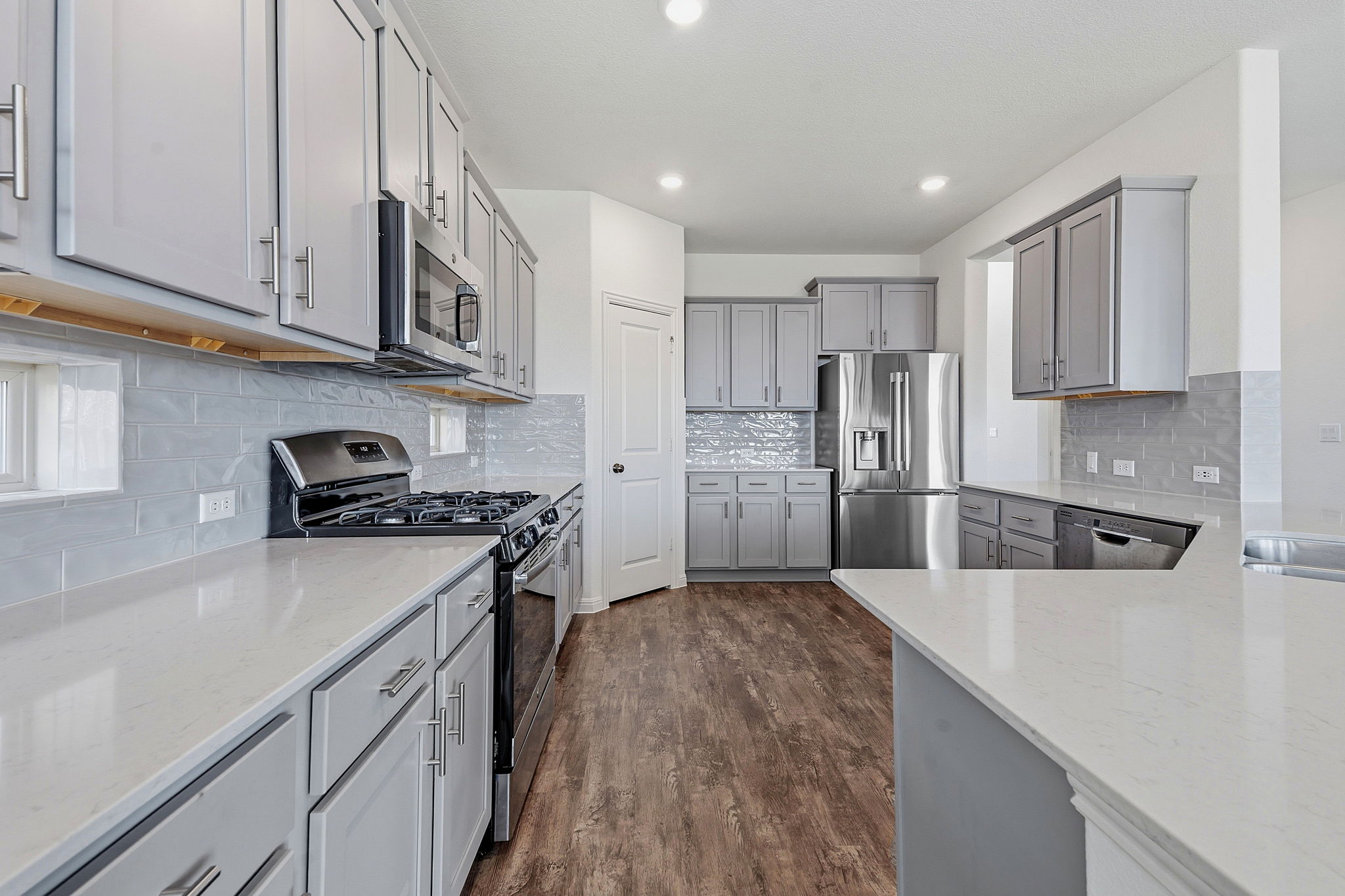 609 Allende Bend, Unit 130 Austin, TX 78748 - Photo 7 of 33 a kitchen with stainless steel appliances granite countertop a refrigerator sink and stove