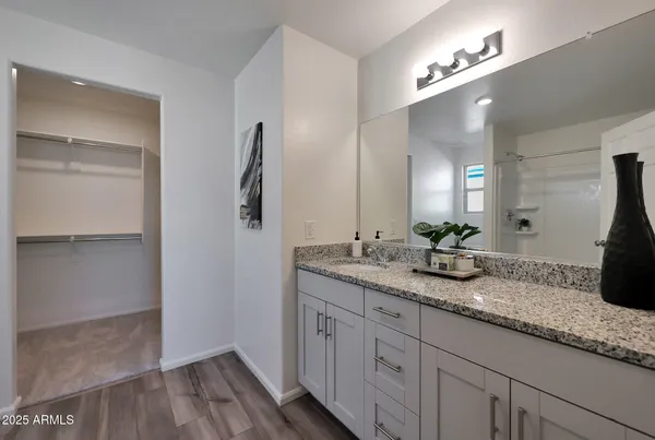 a bathroom with a granite countertop sink double and mirror