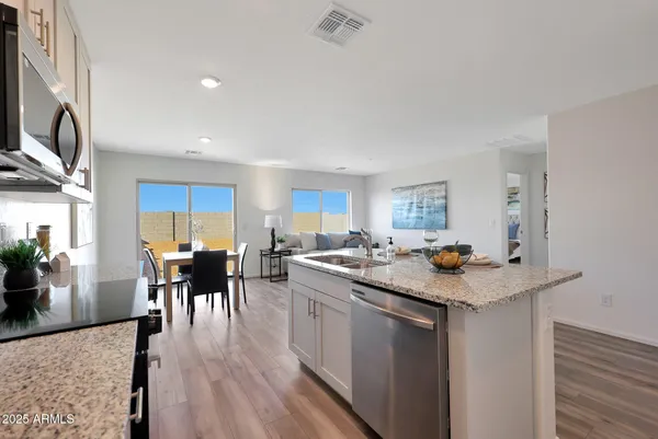 a kitchen with a stove a table and chairs in it