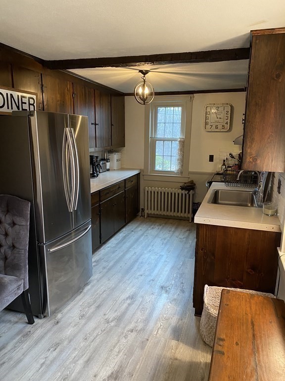 54 Northbridge Road Mendon, MA 01756 - Photo 14 of 39 a kitchen with stainless steel appliances granite countertop a refrigerator a sink dishwasher a stove and a dining table with wooden floor