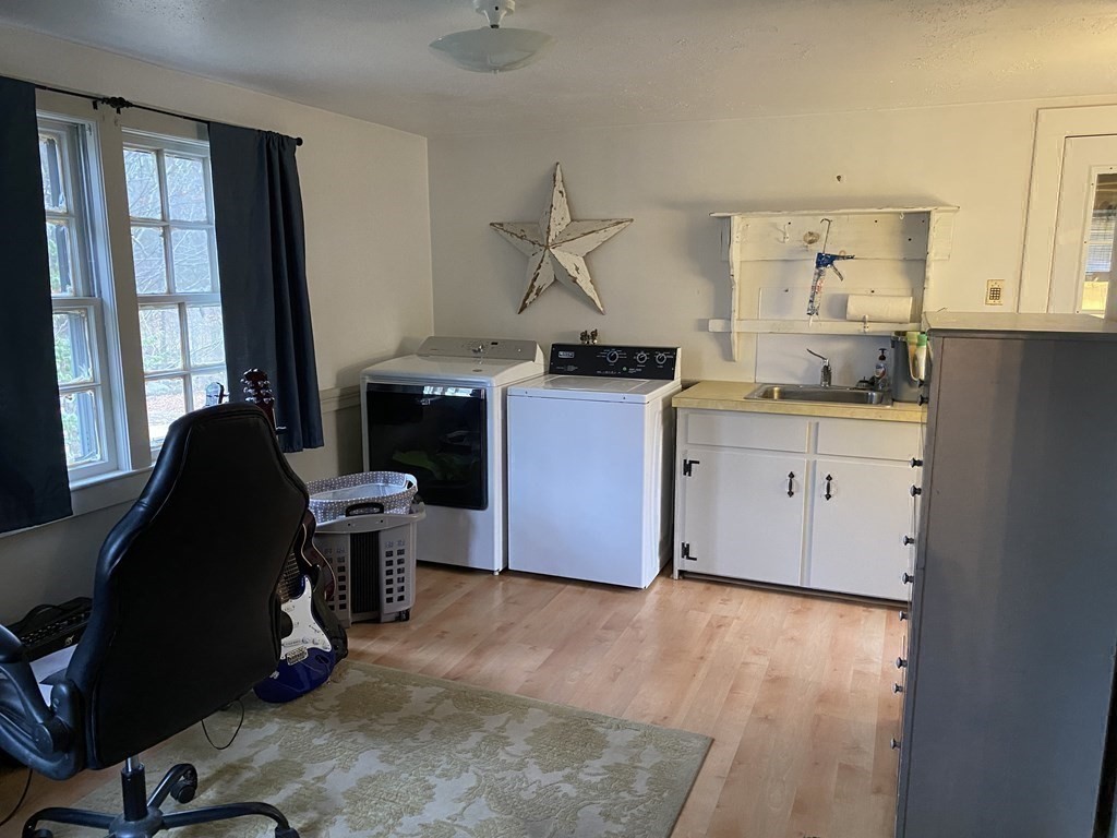 54 Northbridge Road Mendon, MA 01756 - Photo 29 of 39 a kitchen with kitchen island a counter top space a sink a refrigerator and a view of living room