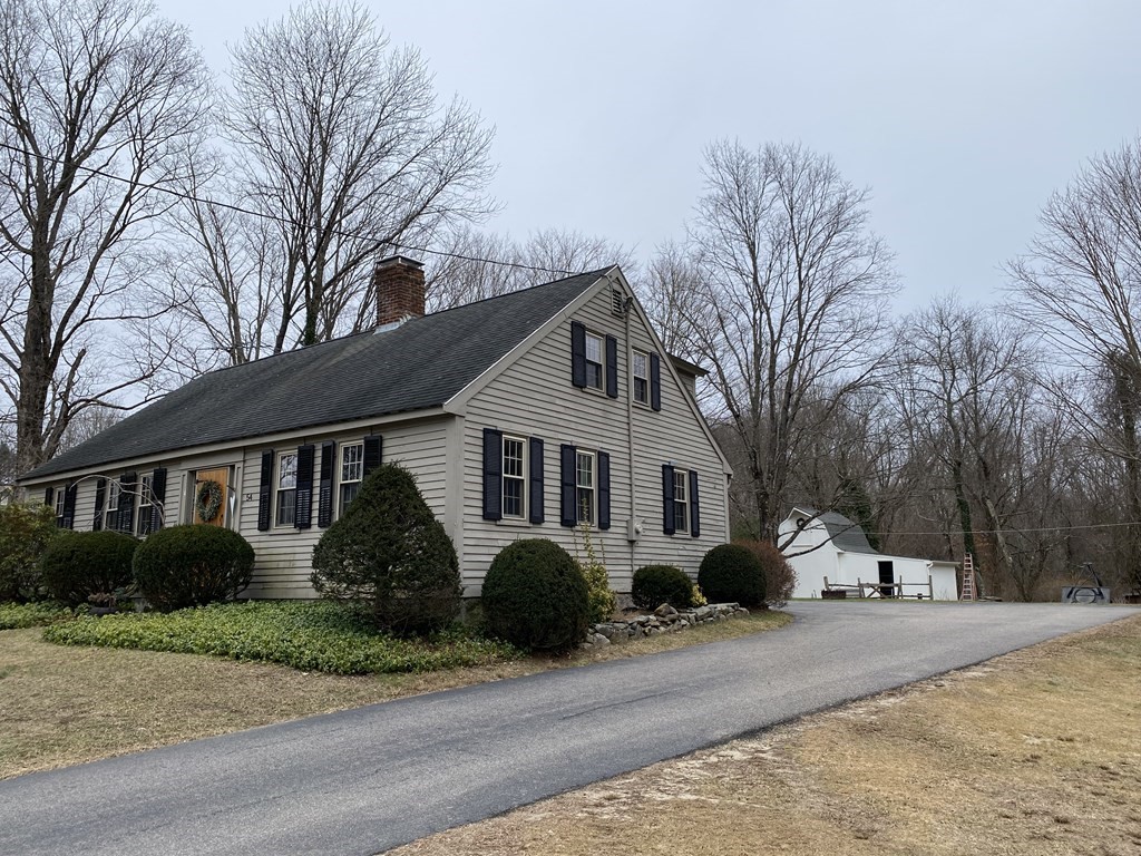 54 Northbridge Road Mendon, MA 01756 - Photo 3 of 39 a front view of a house with a yard and garage