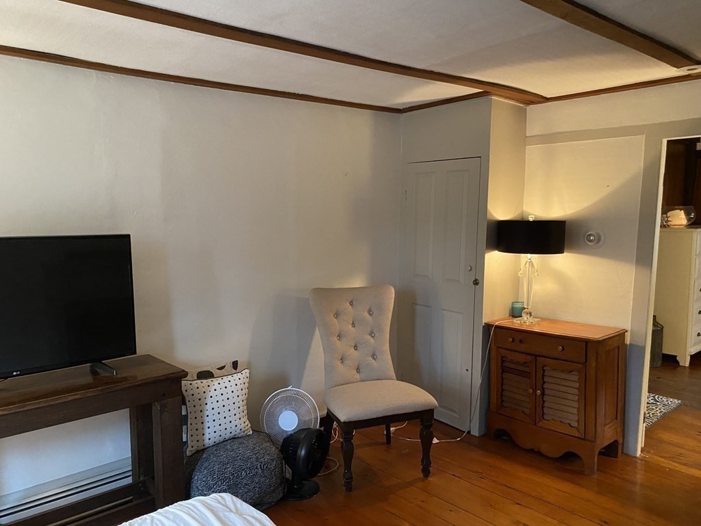 54 Northbridge Road Mendon, MA 01756 - Photo 8 of 39 a living room with furniture and a flat screen tv