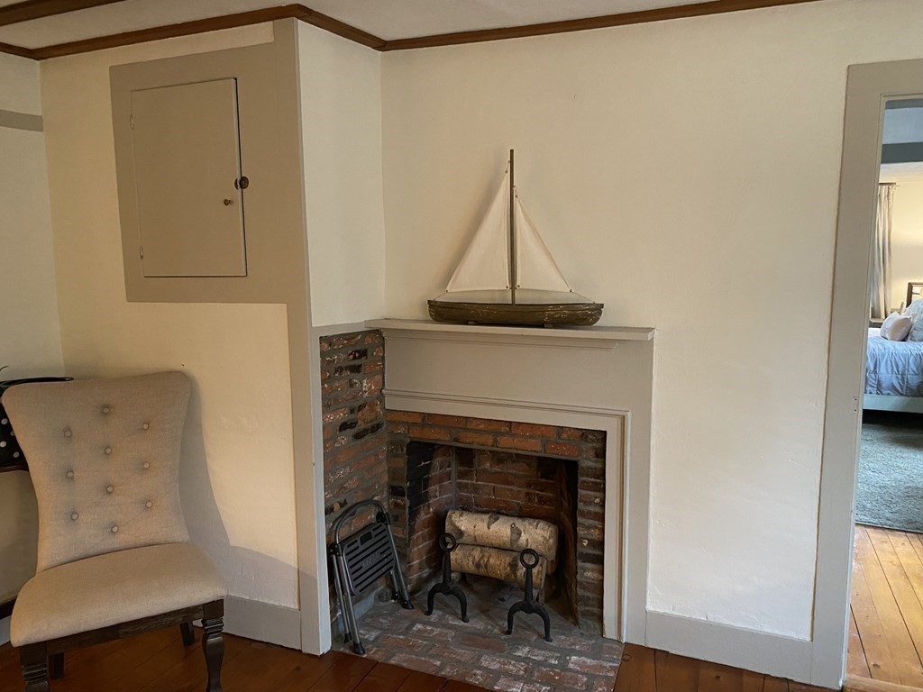 54 Northbridge Road Mendon, MA 01756 - Photo 9 of 39 a living room with a fireplace furniture and a window
