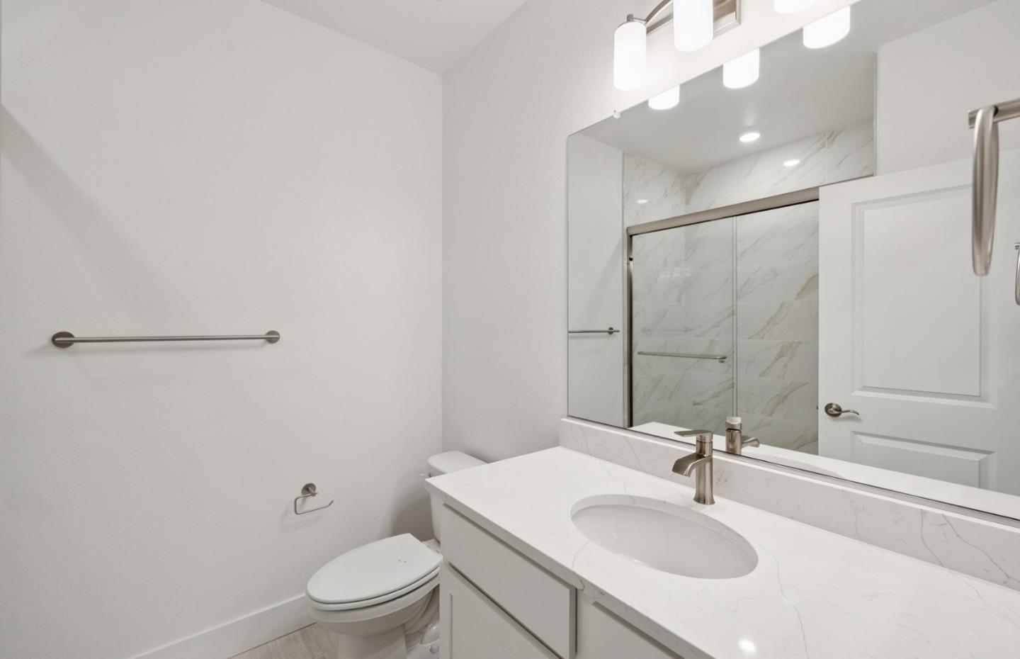 1357 Lilac Way Milpitas, CA 95035 - Photo 14 of 62 a bathroom with a sink toilet a mirror and shower