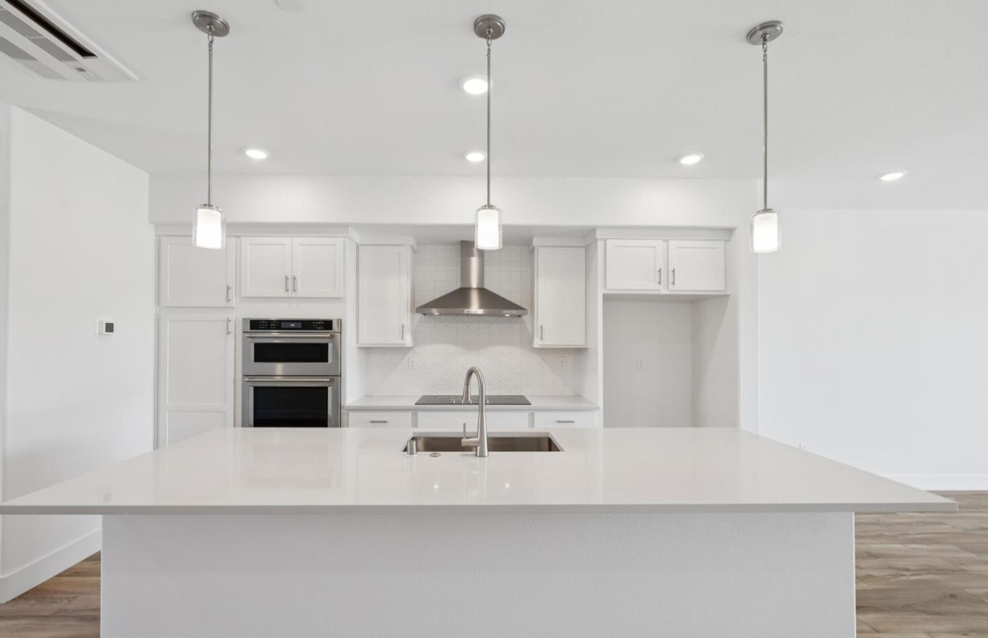 1357 Lilac Way Milpitas, CA 95035 - Photo 21 of 62 a large kitchen with white cabinets and stainless steel appliances