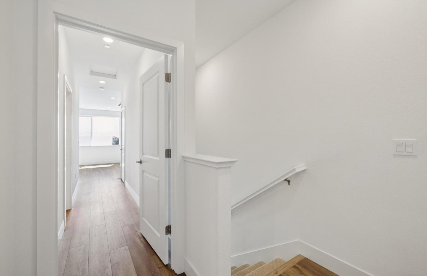 1357 Lilac Way Milpitas, CA 95035 - Photo 40 of 62 a view of a hallway with wooden floor and a bathroom
