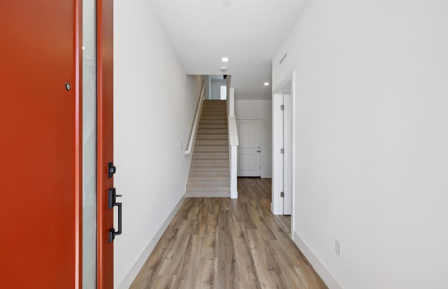 1357 Lilac Way Milpitas, CA 95035 - Photo 8 of 62 a view of a hallway with wooden floor and staircase