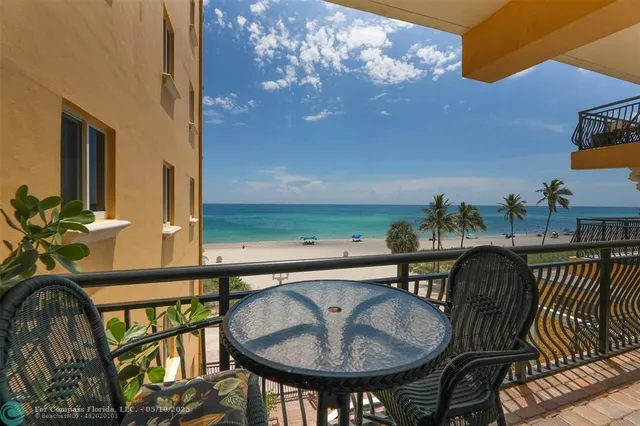 a balcony with table and chairs