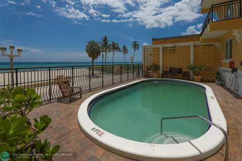 a view of a swimming pool with outdoor seating